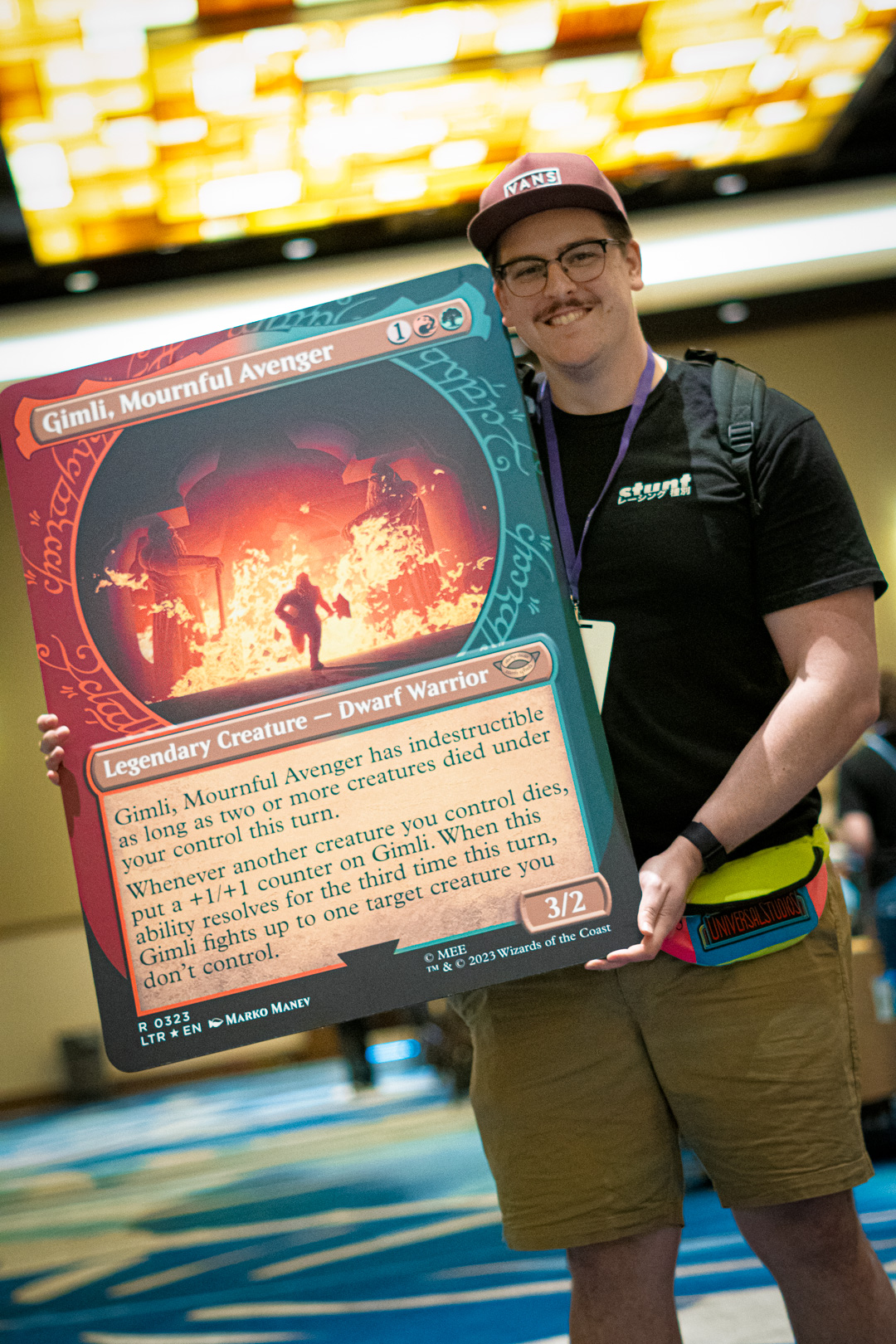 Player holding an oversized card of Gimli, Mournful Avenger