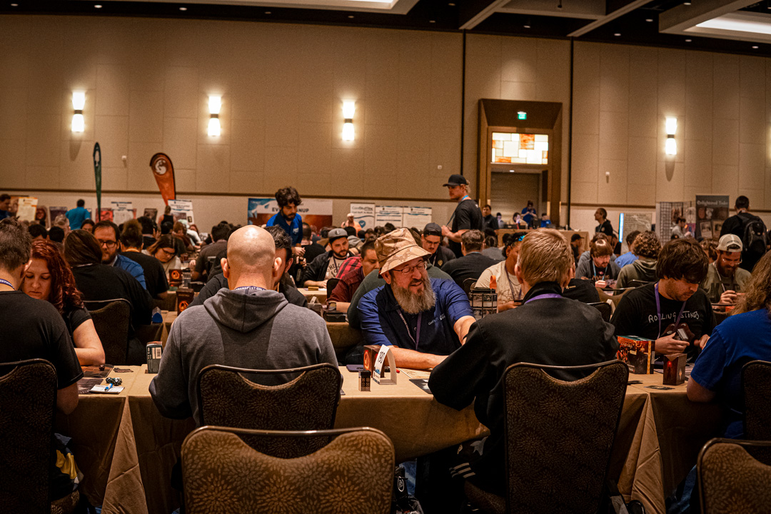 Wide shot of gaming tables filled with players