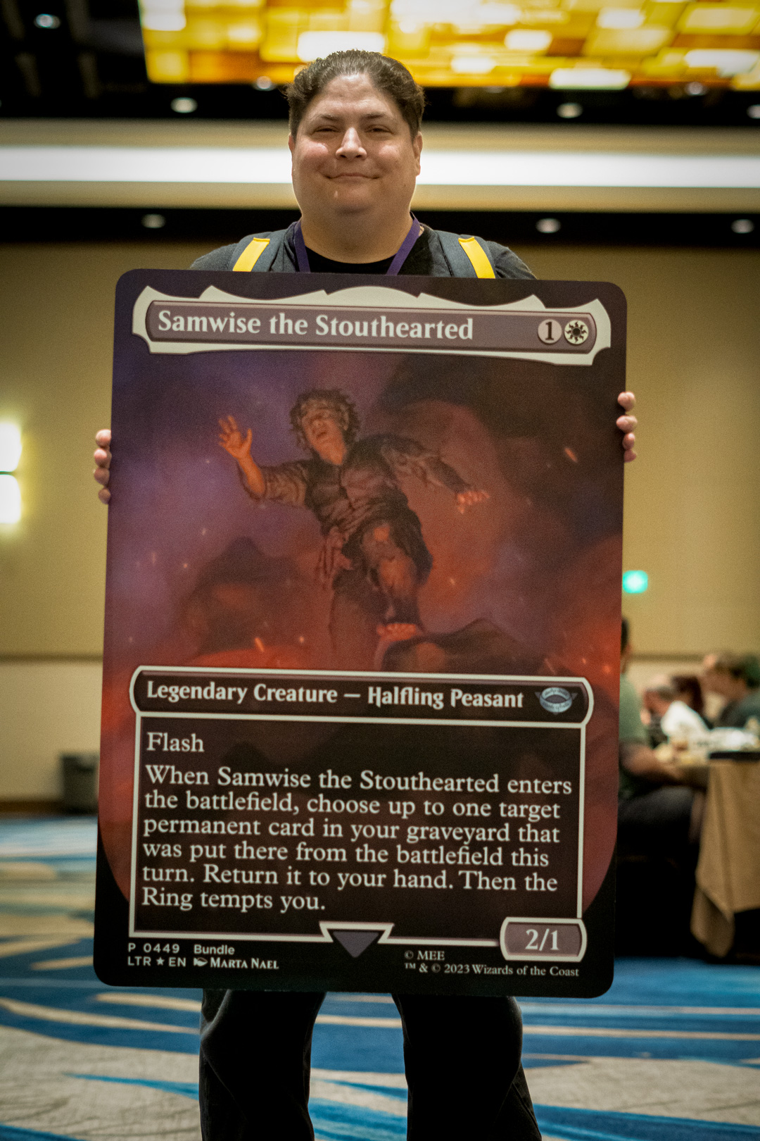 Player holding an oversized card of Samwise the Stouthearted